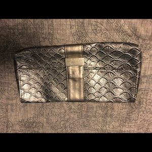 Silver redken makeup clutch.